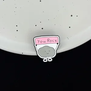 Cute rock enamel pin, inspiring You Rock brooch badge for backpack clothing accessories detail.