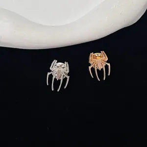 Close-up detail view of elegant metal spider brooch pins in silver and gold finishes, perfect.