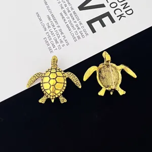 Close-up view of the detailed gold alloy turtle brooch showing both front and back design.