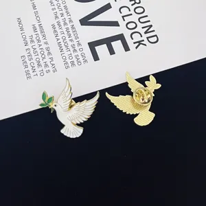 Detailed view of the elegant peace dove enamel pin, showing front design and back clutch.