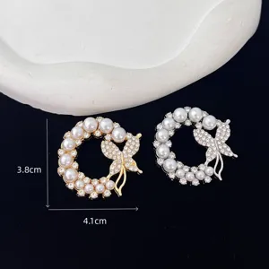 Exquisite pearl butterfly brooch detailed view, elegant sweater coat accessory pin for women.