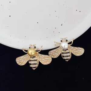 Crystal pearl bee brooch detail shot, elegant insect lapel pin for women's blazer.