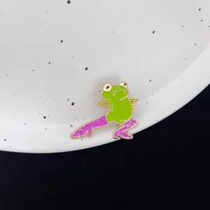 Close-up of a cute funny green frog enamel pin wearing sparkling high heels for outfits.