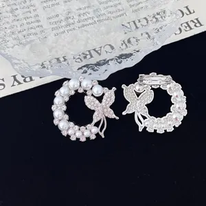 Detailed close-up of pearl and rhinestone butterfly wreath brooch back and front view.