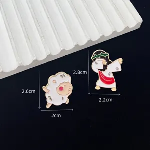 Detailed close-up shot of cute cartoon sheep and Jesus dab enamel pins with size dimensions.