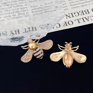 Detailed shot of rhinestone pearl bee brooch, exquisite gold crystal insect pin back view.