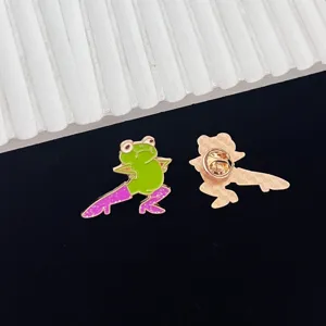 Close-up detail of the funny green frog enamel pin wearing stylish purple high heels.