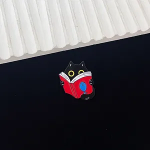 Cute black cat reading a book enamel pin, creative animal cartoon metal badge for backpacks.