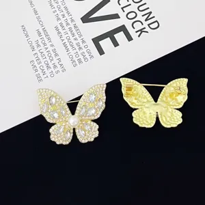 Rhinestone butterfly brooch detail view, showing sparkling crystals and pin mechanism.