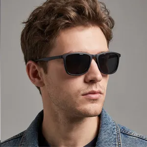 Close-up of stylish black square sunglasses worn by male model, ideal for outdoor sports.
