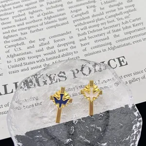 Close-up detail of metal peace dove cross brooches, exquisite enamel design for accessories.