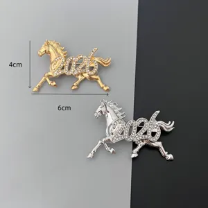 Detail view of 2026 zodiac horse rhinestone brooch in gold and silver finish 6cm size.
