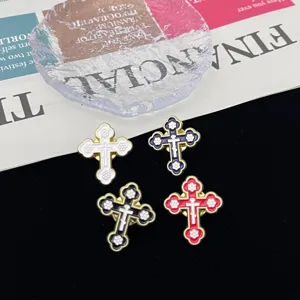 Close-up shot showing exquisite details of gothic cross metal brooches in four distinct colors.