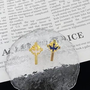 Metal cross dove brooch detail shot, elegant religious style lapel pin for clothing accessories.