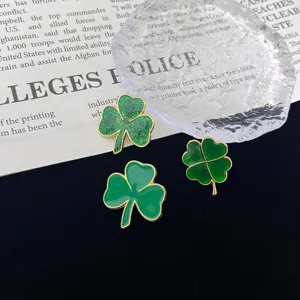 Detailed shot of clover enamel brooches, fashionable green pins for women and daily wear.