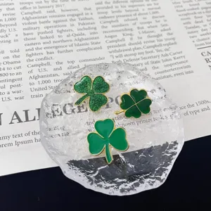 Close-up of green clover brooch set, exquisite enamel texture and metal craftsmanship.