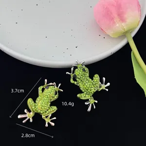 Exquisite crystal rhinestone frog brooch detail shot, sparkling alloy animal jewelry feature.