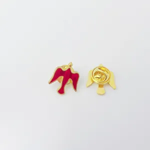 Gold metal red enamel bird dove lapel pin brooch close-up detail view clothing accessory badge