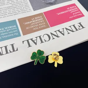 Exquisite shamrock brooch detail showing green glitter finish and back pin structure design.