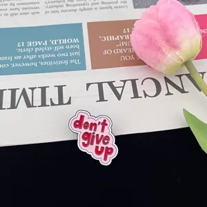 Enamel lapel pin with inspiring English quote don't give up design, detailed badge accessory.