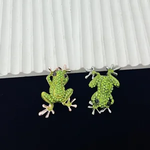 Close-up detail shot of exquisite alloy rhinestone frog brooch, featuring sparkling green crystals.