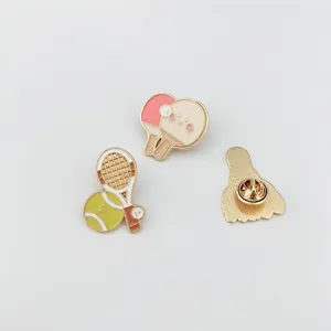 Cute sports metal enamel pin set featuring tennis racket and ping pong paddle designs for bags.