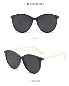Stylish black and white oval sunglasses for women, offering UV protection and chic designer style.