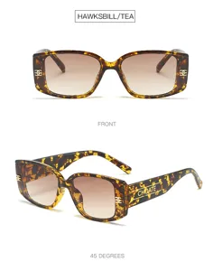 Detailed shot of tortoiseshell square sunglasses with thick frames and gradient lenses.