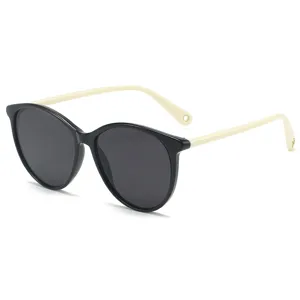 Chic black and beige oval sunglasses for women, stylish lightweight sun protection eyewear.