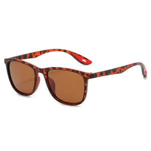 Trendy vintage tortoise shell sunglasses with brown lenses and red temples, main view.