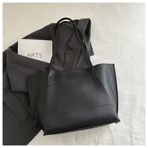 Borsa shopper nera minimalista in pelle, elegante vista dettagliata della borsa a spalla.
