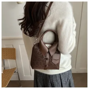 Primer plano del bolso de mujer creativo en forma de camisa con estampado de leopardo.