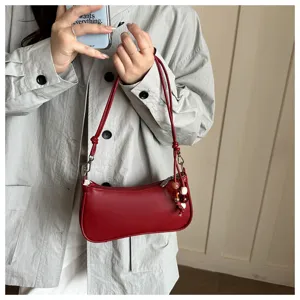 Red shoulder bag detail shot, PU leather hobo bag with delicate strap and cute beaded charm.