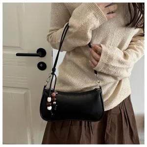 Minimalist black baguette shoulder bag for women, chic trendy underarm purse with cute bead charm.