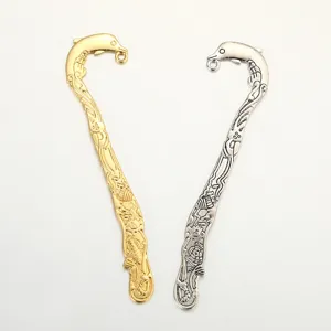 Detailed close-up view of carved metal dolphin bookmarks featuring dual gold and silver finishes.