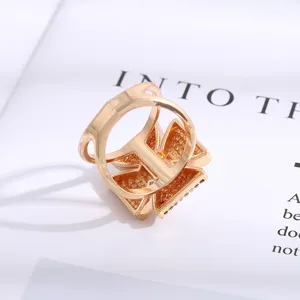 Detailed shot of golden cross motif scarf buckle accessory, exquisite textured metal craftsmanship.