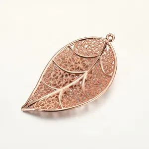 Close-up of a delicate rose gold hollow leaf pendant, perfect for DIY jewelry crafting.