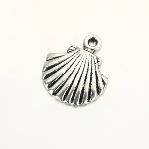 Close up of vintage silver seashell pendant charm detail for DIY jewelry making and crafting.