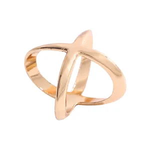 Detailed view of the elegant cross-shaped silk scarf buckle with smooth gold finish.