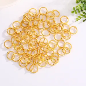 Closeup of gold metal spacer beads, hollow geometric DIY jewelry making findings.