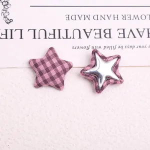 Detail shot of pink plaid star buttons, DIY craft fabric patches, close-up accessories view.
