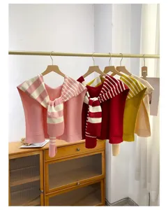 Knitted shoulder wrap and scarf detail shot, cozy fabric and stylish stripe design for wear.
