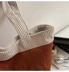Close-up detail showing the premium corduroy fabric and ribbed texture of the stylish tote bag.