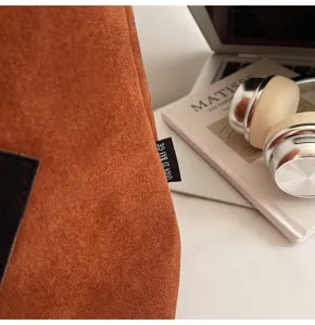 Brown suede tote bag closeup, casual large-capacity shoulder bag detail showing texture.