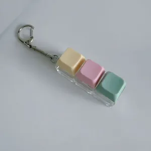 Porte-clés jouet anti-stress avec interrupteur mécanique pastel à 3 touches pratique.