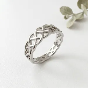 Silver Celtic knot ring for women, intricate woven hollow design, elegant vintage finger jewelry.