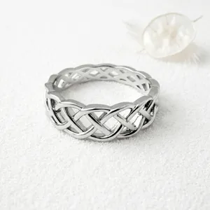 Silver Celtic knot ring featuring an intricate woven hollow design, chic minimalist style.