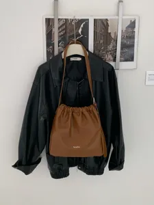Stylish brown faux leather drawstring shoulder bag, casual cloud bucket bag for women daily commute.
