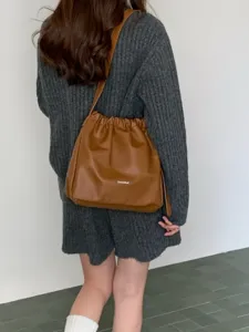 Casual minimalist brown pleated cloud shoulder bag, versatile commuter crossbody bucket bag.