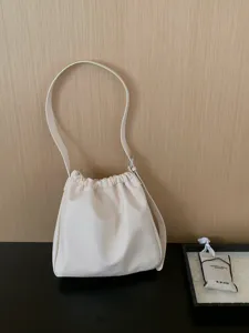 Minimalist pleated cloud bucket bag for women, chic casual commuter shoulder crossbody bag.